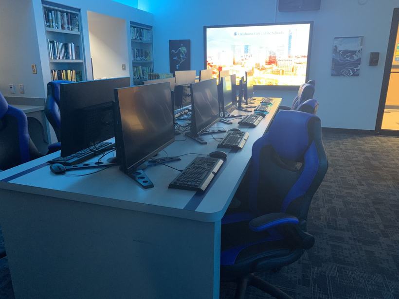 Library esports bay with gaming chairs and monitors.