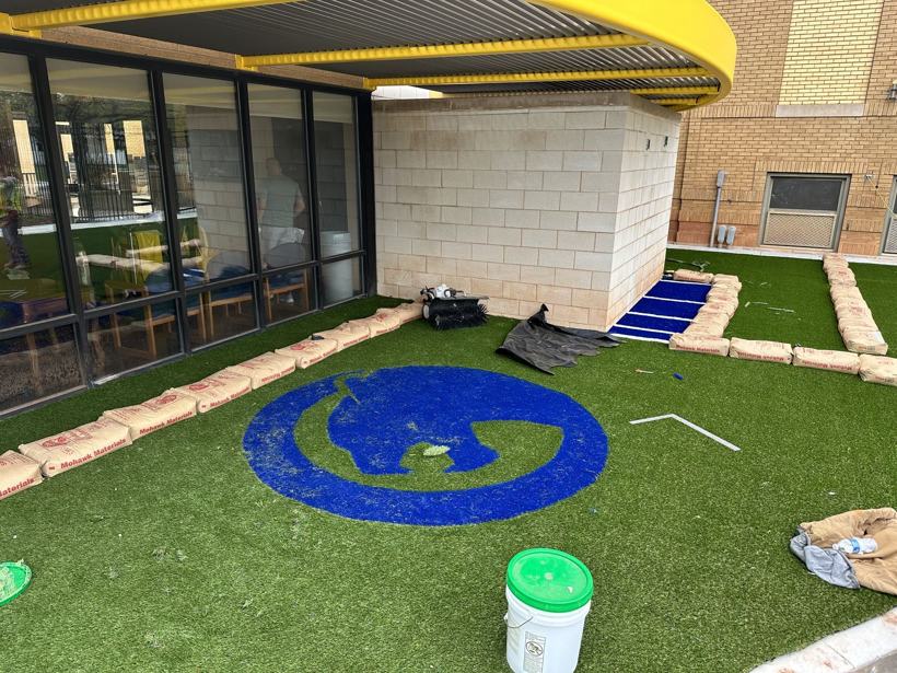 Panther logo cut into the turf during installation.