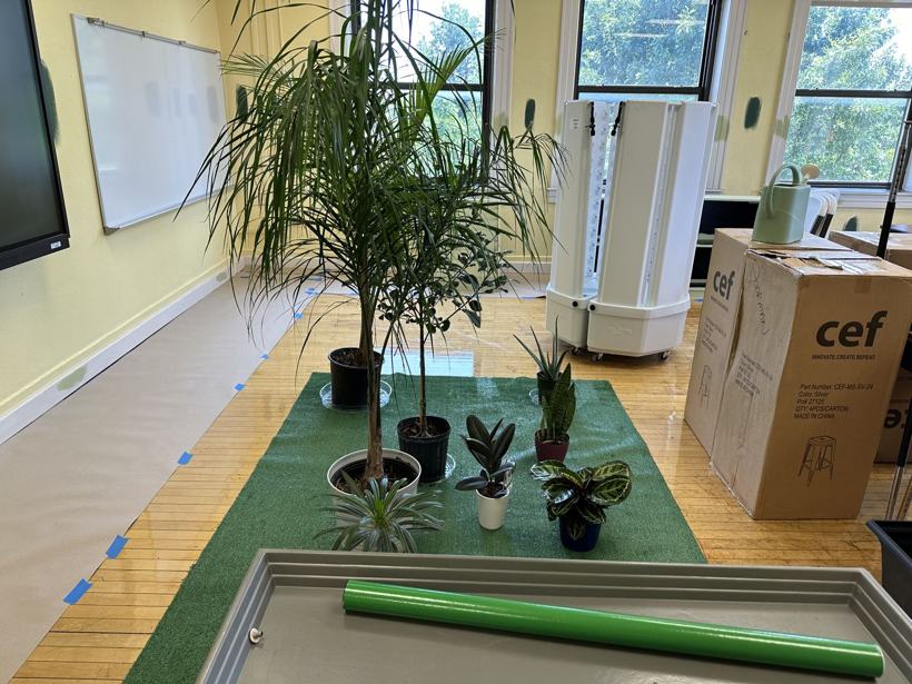 Plants and vertical grow towers staged in the new biology room.