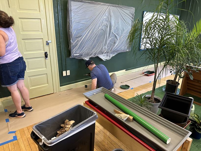 Volunteers cutting in trim in the biology room.