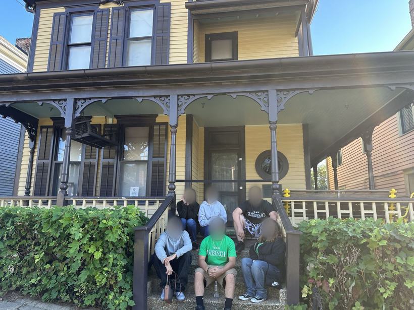 Six students on the steps of a historic house in Atlanta. Faces blurred.